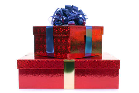 Small stack of red gift boxes with blue ribbon bow isolated on white backgroundの写真素材