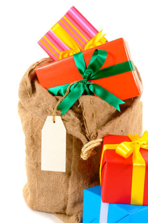 Santa sack full with pile of Christmas gifts isolated on white backgroundの写真素材