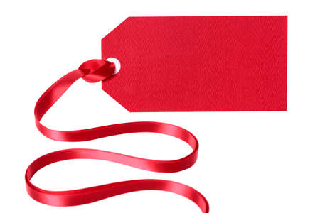 Red gift tag or label with ribbon isolated on white backgroundの写真素材