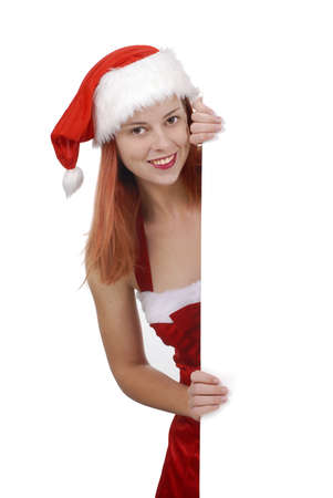 Smiling young adult woman in Santa hat holding plain white blank billboard or sign, shopping retail conceptの写真素材
