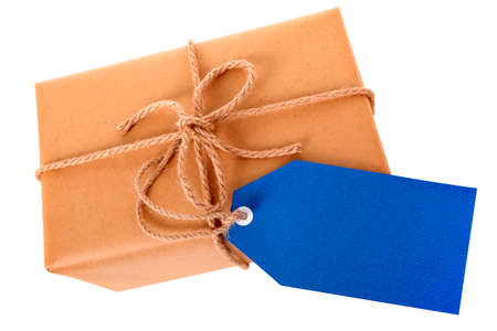 Plain brown paper package or parcel, blue gift tag or label and ribbon isolated on white background, top viewの写真素材