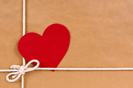 Valentine gift with gift tag, brown paper package parcel background, copy spaceの写真素材