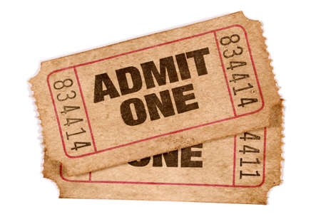 Two old torn and stained admit one movie ticketsの写真素材