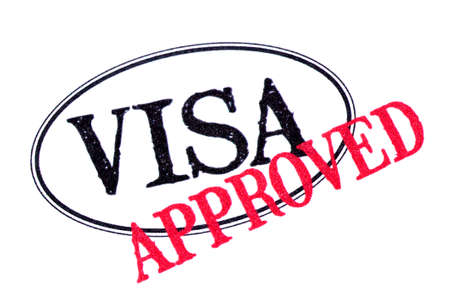 Approved visa passport rubber stamp isolated on white backgroundの写真素材