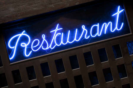 Neon blue restaurant sign closeupの写真素材