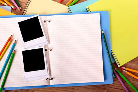 Photo album open with several blank style photo print frames, copy space