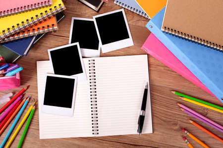 Photo album and several style instant photo print frames on a school deskの写真素材