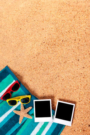 Summer vacation photo frame album prints on a beach backgroundの写真素材