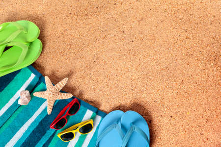 Summer beach background border, flip flops, sand copy space