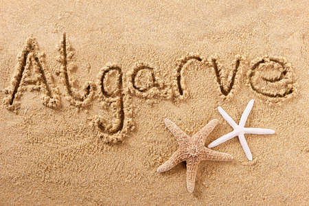 Algarve portugal beach word written in sandの写真素材