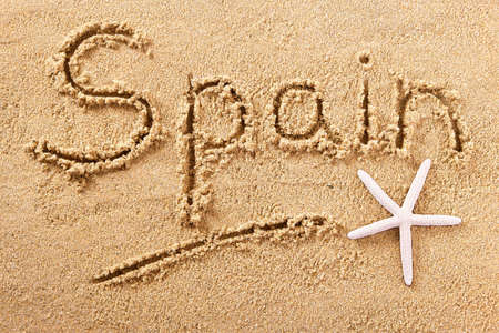 Spain beach word written in sandの写真素材