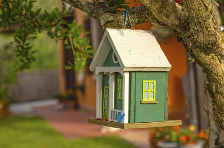 wooden birdhouse in the gardenの写真素材