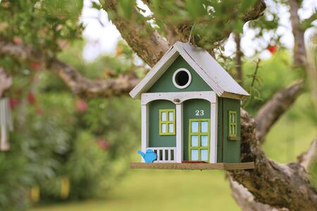 hang wooden birdhouse in the gardenの写真素材