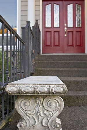 Stone Garden Bench with Architectural Detail with Red Front Doorの写真素材