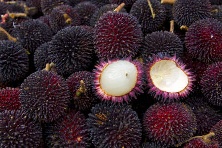 Buah Pulasan Fruit on Vendor Stand in Tropical Countryの写真素材