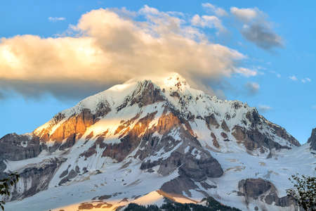Mount Hood and clouds over mountain top peak during summer closeup in oregon