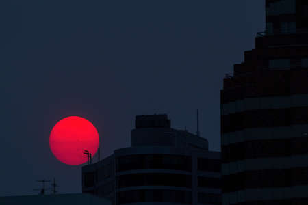 Sunset over the city of Portland Oregon downtown during a smoky evening from wildfiresの写真素材