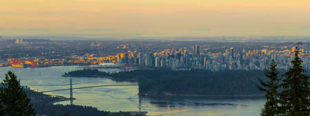 Sunrise over Vancouver British Columbia Canada city skyline Stanley Park and Lions Gate Bridge panoramaの写真素材
