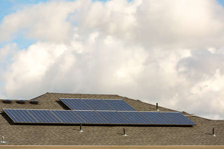Solar Panels on rooftop of residential home in North American suburban neighborhoodの写真素材