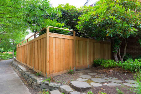 New Cedar Wood Fence with gate door on home side yard landscapingの写真素材