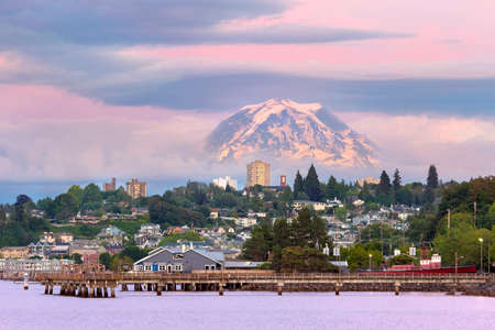 Mount Rainier over Tacoma Washington waterfront during alpenglow sunset evening