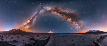 Majestic galaxy view above snowy mountain peaks at twilightの素材