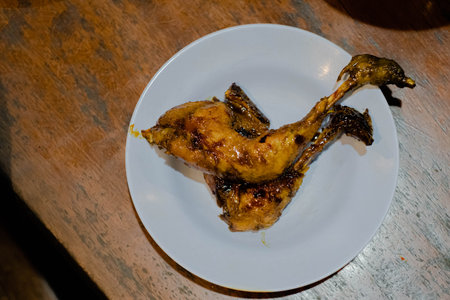 Flat lay shot or top view of roasted chicken in the white plate