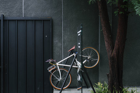 Individual bicycle parking lot with black steel gate and dark grey concrete wallの写真素材