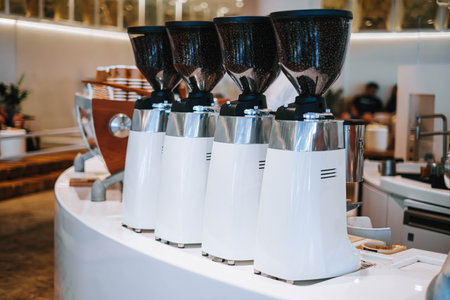 White coffee grinders in a cafe. Bokeh adds a dreamy touch to this image, capturing the essence of a...