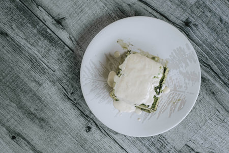 Flat lay shot of a Japanese Matcha Cake and Creamy Custard on a wooden tableの写真素材