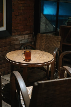 Portrait or vertical shot of a glass of tea on the traditional table and interior with blurred foreground and backgroundの写真素材