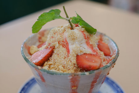 Close-up shot of a glass of Strawberry Bingsoo or Bingsu with bokeh or blurred backgroundの写真素材