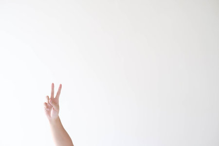 A man's hand with peace symbol or gesture on an isolated white background