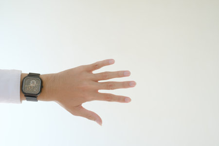 A hand with a white shirt and a watch. Isolated white background.