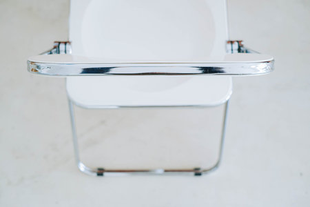 Selective focus shot of Italian vintage white folding chair. Blurry background.の写真素材