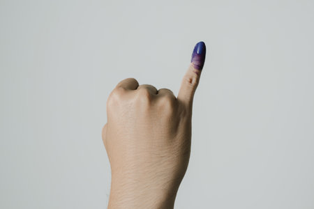 Purple ink applied on little finger after pemilu or Indonesian presidential electionの写真素材