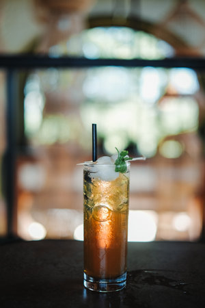 Two lychee fruit with mint leaves in a glass of lemon juice. Bokeh background.の写真素材