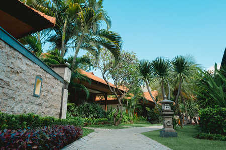 Balinese resort with pavement pathway through tropical gardenの写真素材
