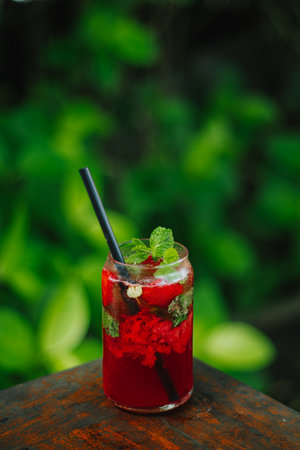Strawberry cocktail with mint leaves and ice. Bokeh background.の写真素材