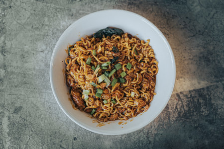Mie Bangladesh with boiled egg and some vegetables made from instant noodles originate from Medan or...