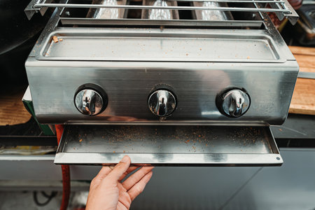 Cleaning dirty gas roaster made of stainless steel with bokeh backgroundの写真素材
