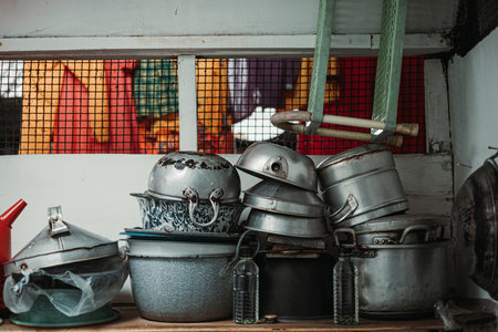 Stacked rustic steel kitchen utensils on the shelf