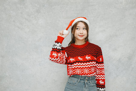 Smile face of a young Asian Santa woman. Suitable for promotional material during holiday season.の写真素材