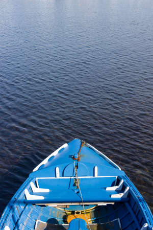 A small blue wooden fishing boat.の写真素材