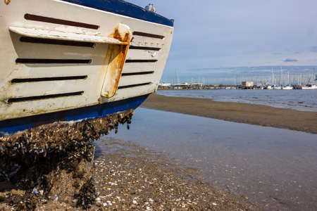 A fishing boat washed up on a beach from a  recent storm in Melbourne.の写真素材