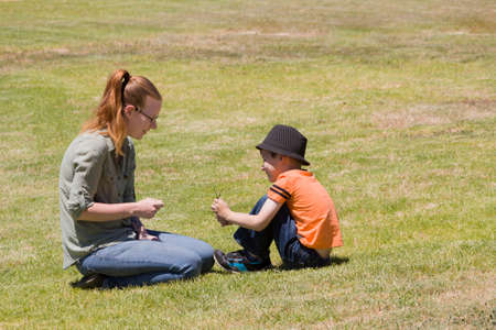 Happy scene of a mother and her son playing in a park on a suny day.のeditorial素材