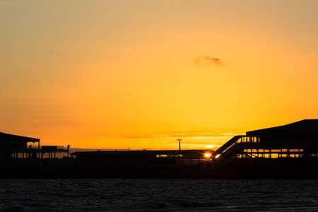 Silhouette of Station Pier in Melbourne with the sunsetting in the background.の写真素材