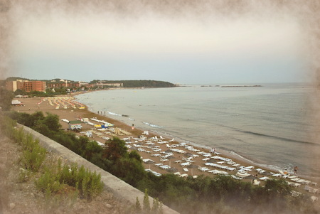 Sandy beach on the shores of the Mediterranean Sea with sun beds and hotels.の写真素材