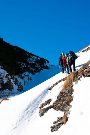 A group of hikers in Bucegi mountains, in winter seasonの写真素材