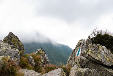 Blue and white hike path symbol in the mountains.の写真素材